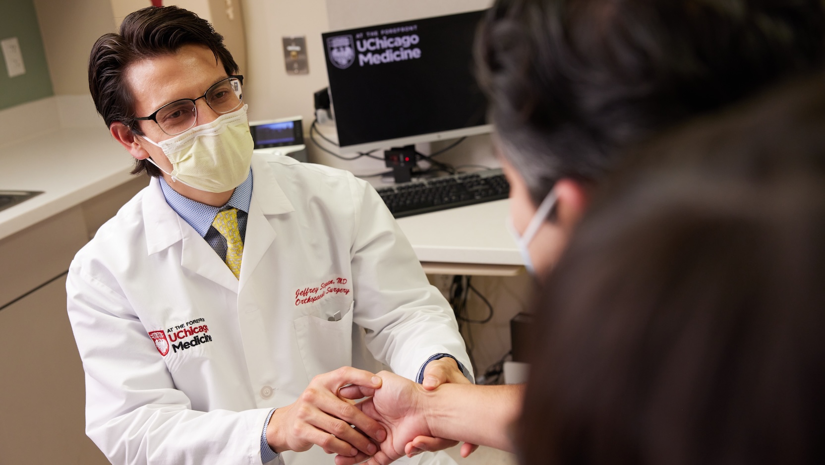 UCM physician holding patient's wrist
