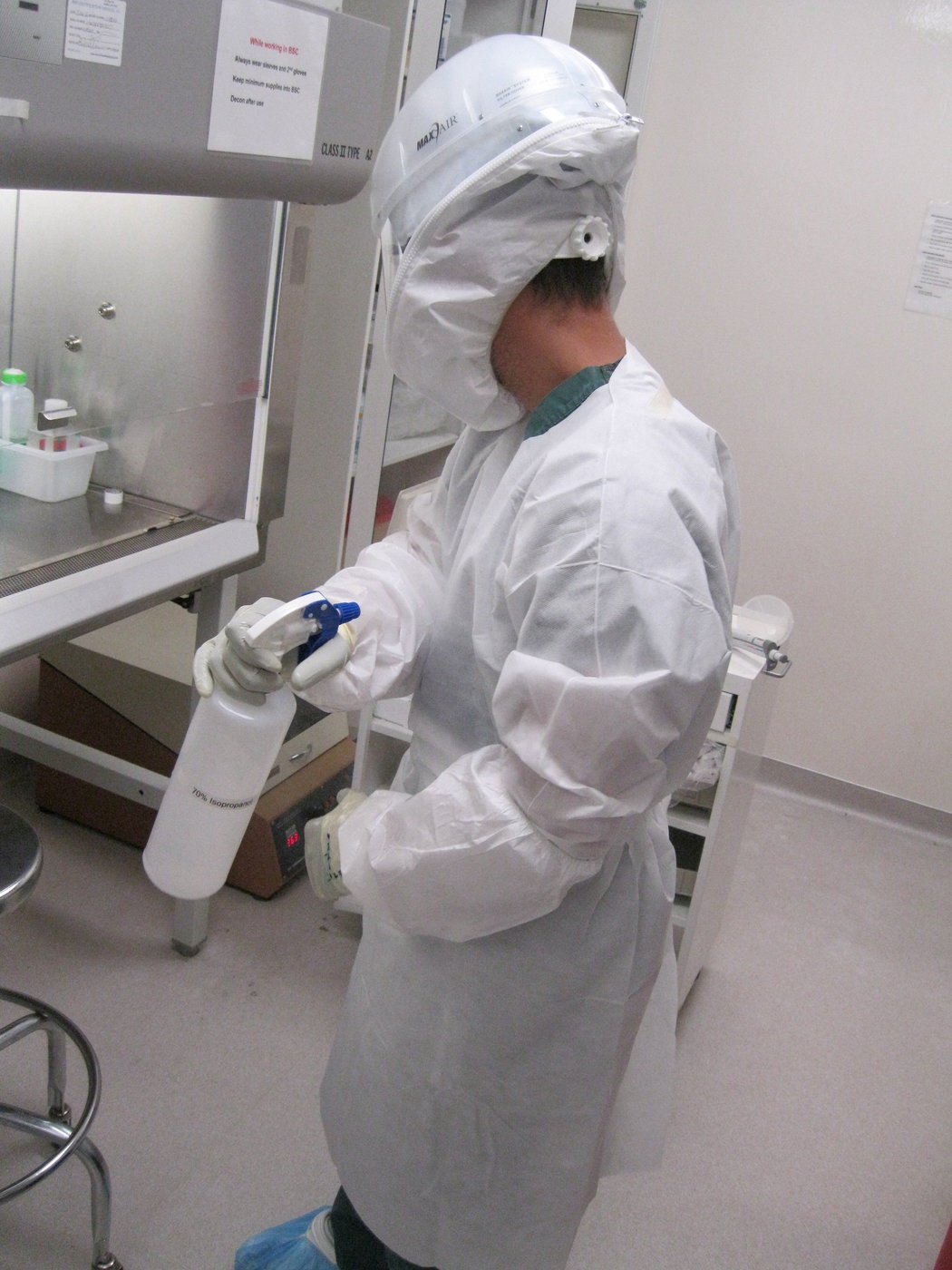 Researcher with spray bottle in lab