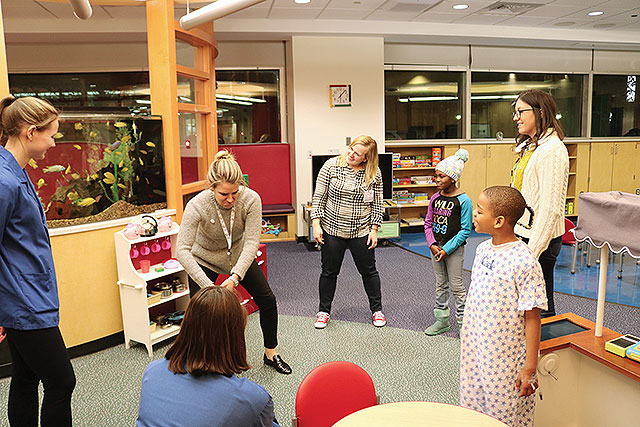 Improv comedy troupe Humor for Hope performs for patients in the Comer Children's playroom