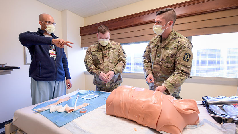 Trauma surgeon David Hampton, MD, teaches two army medics
