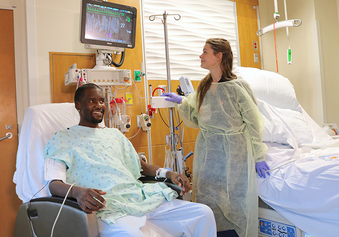 Transplant patient, Daru Smith, with a transplant nurse