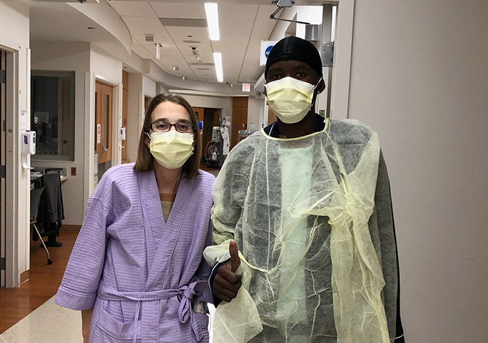 Triple transplant patients, Sarah and Daru, walking together in the hospital