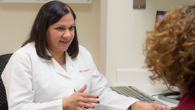 Rita Nanda, MD, medical oncologist, speaks with a patient