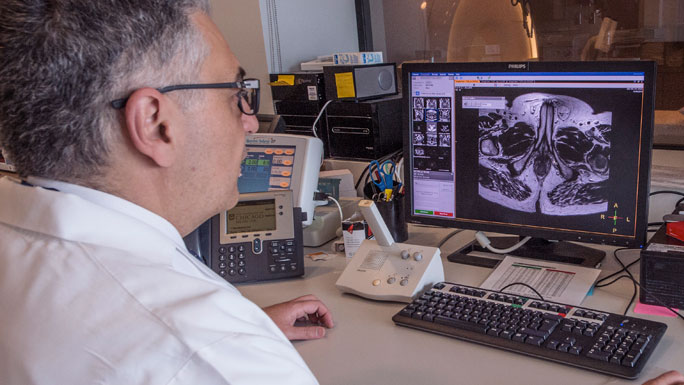 Aytekin Oto, MD, viewing MRI images