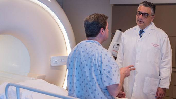 Aytekin Oto, MD, with a patient before his MRI