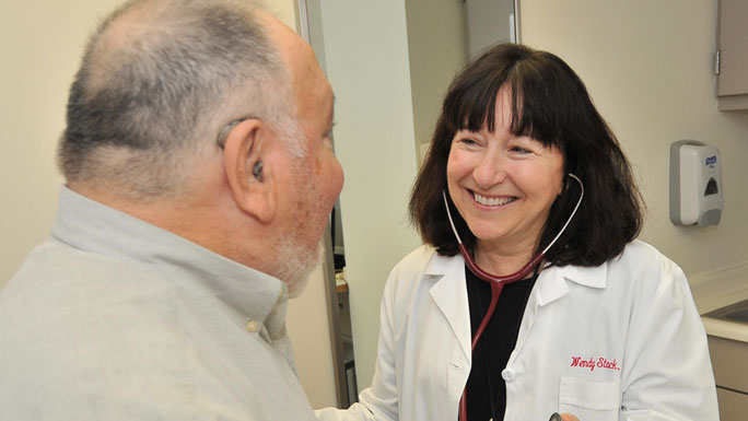Medical oncologist Wendy Stock, MD, with a patient in clinic