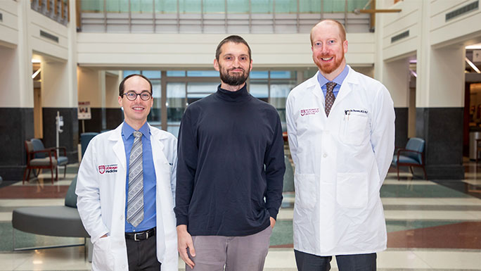 Dmitry Karpeyev, alongside Alexander Pearson, MD, PhD (right) and James Dolezal, MD, is a co-author on a new study in Nature Communications that describes changes to artificial intelligence algorithms to improve their ability to detect cancers.