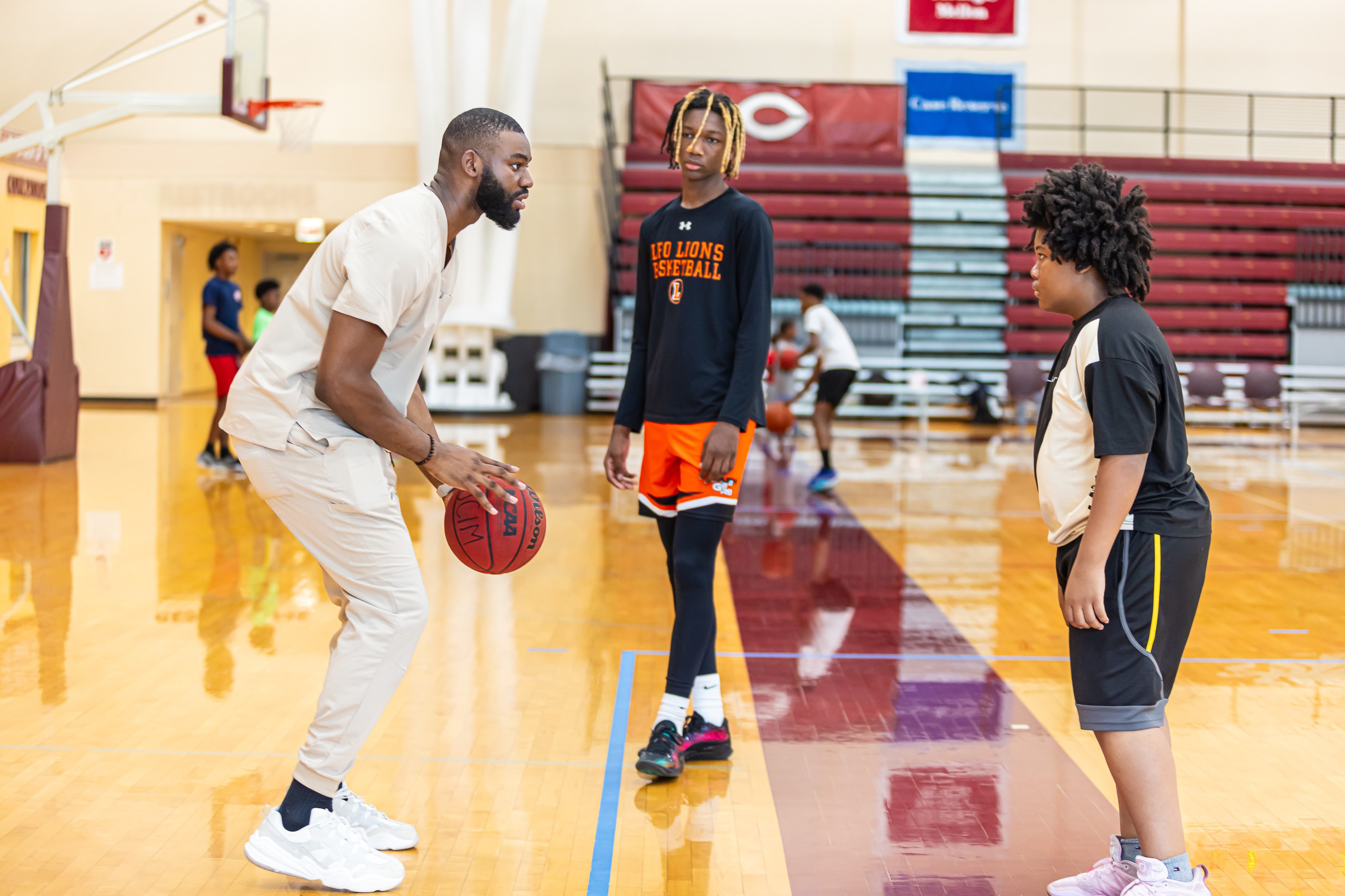 Sneakers to Scrubs co-founder and CEO Jameel Alausa hits the court with attendees at a violence prevention and health fair
