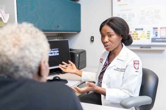 Gynecologist Ayman Al-Hendy, MD, PhD, talking with a patient