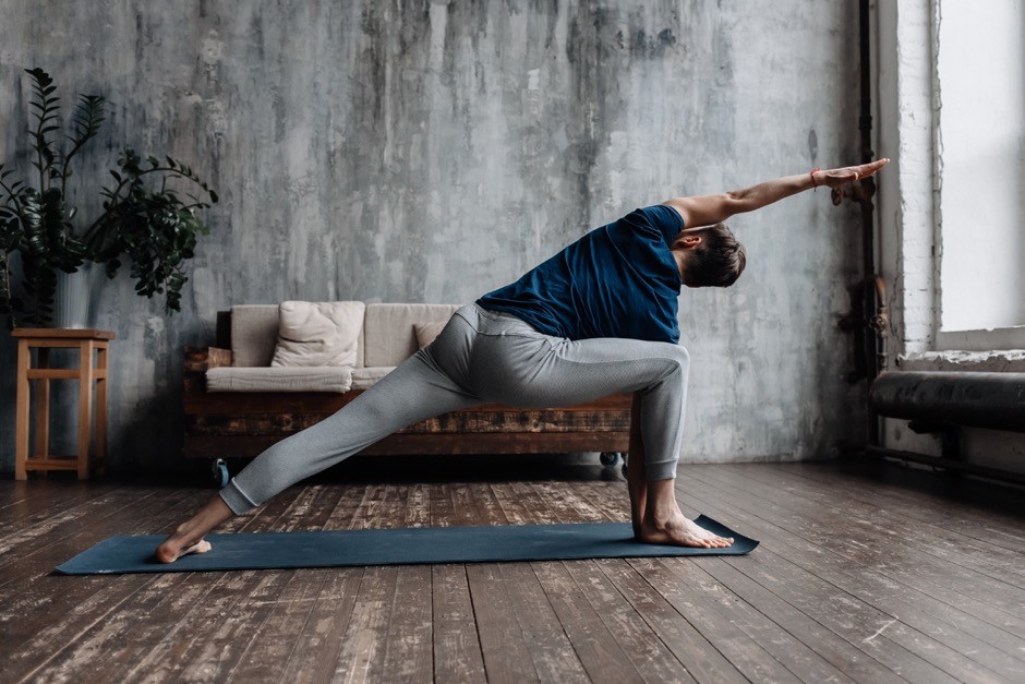A man performs a side spinal stretch.