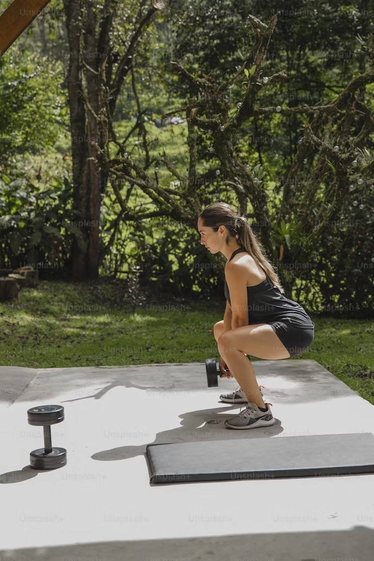 A healthy woman performs a squat.