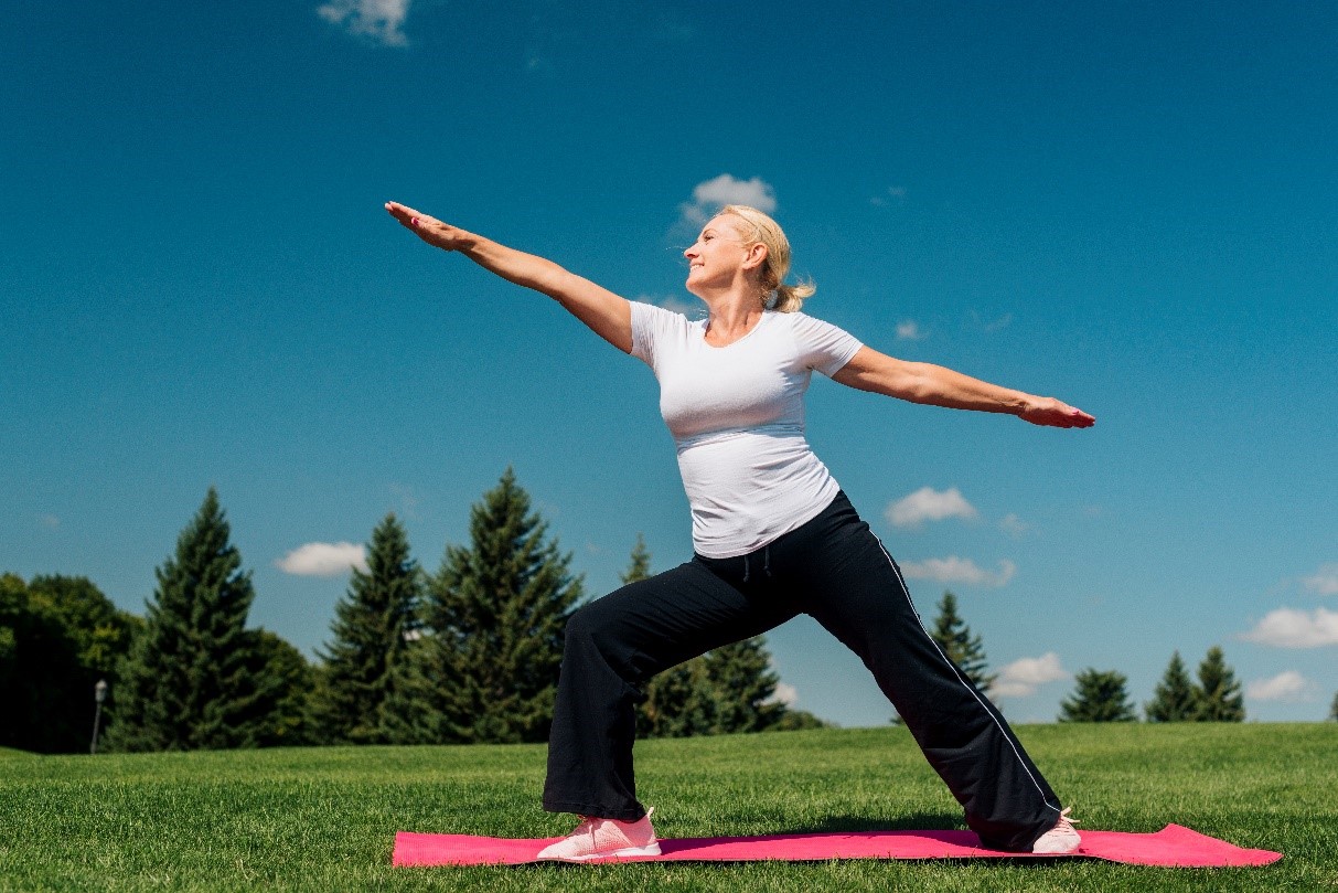 A healthy older woman exercising outdoors.