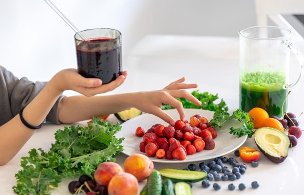 A variety of fresh fruits and juices on a table representing dietary adjustments for colonoscopy preparation.