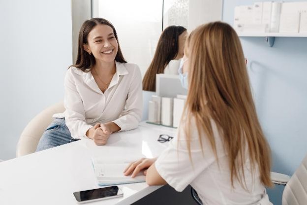A physician discussing breast imaging with an adult patient.
