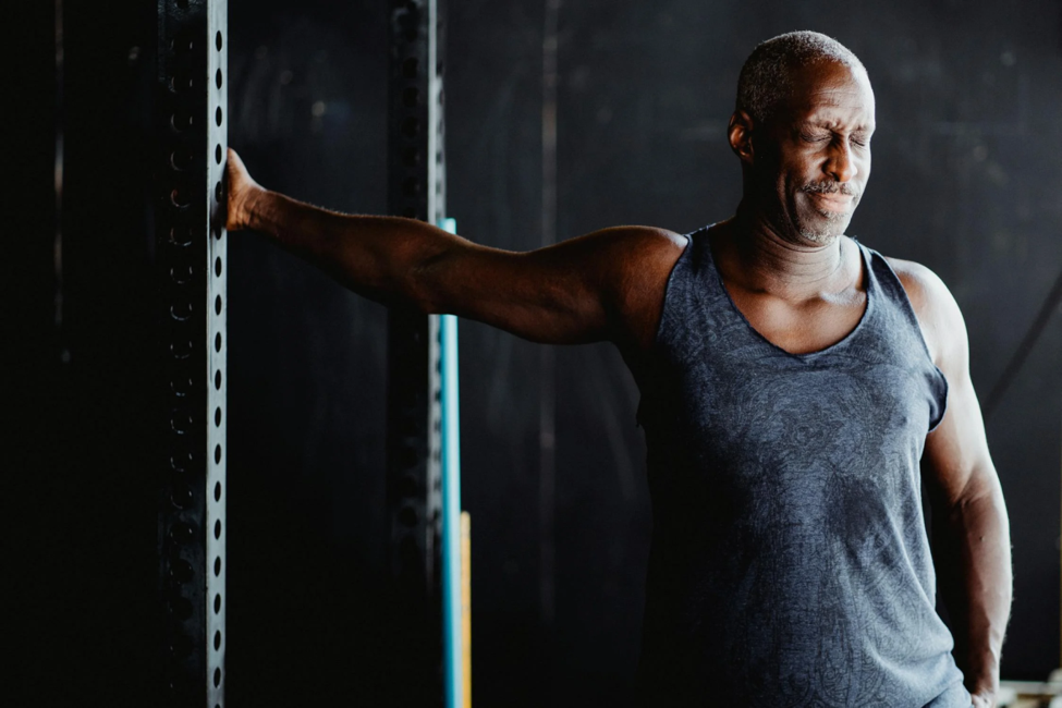 A man performs a shoulder exercise following recovery.