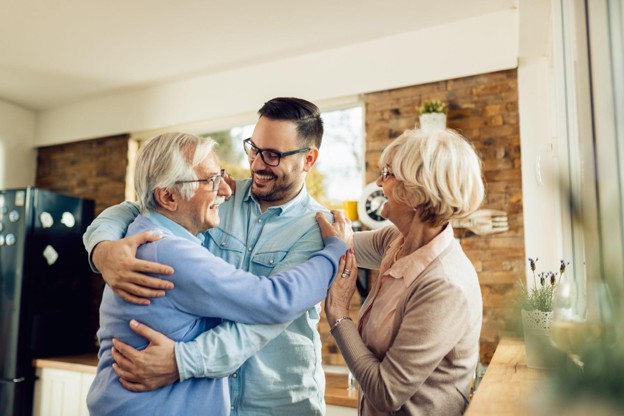 An adult receiving support from family members after returning home following an outpatient surgical procedure