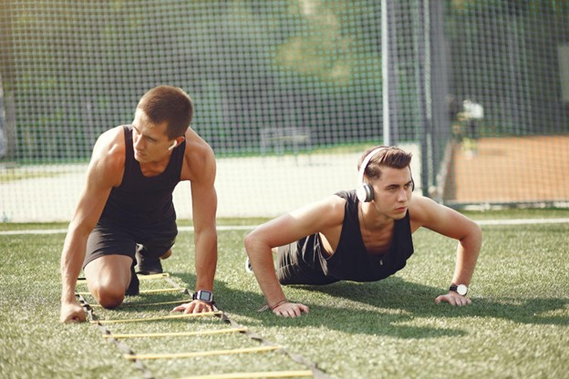 High school athletes performing agility training drills on an obstacle course.