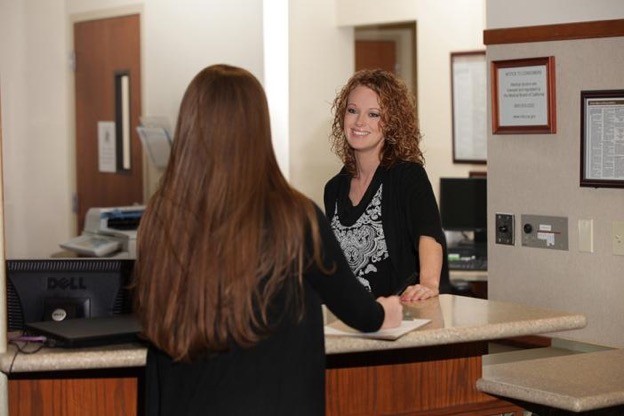 An adult patient checking in at an outpatient surgery center before a scheduled procedure.