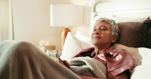 An adult resting comfortably at home during recovery after an outpatient surgical procedure