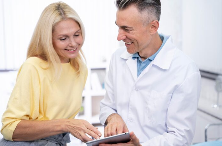 A physician reviewing diagnostic test results with an adult patient during a surgical consultation.