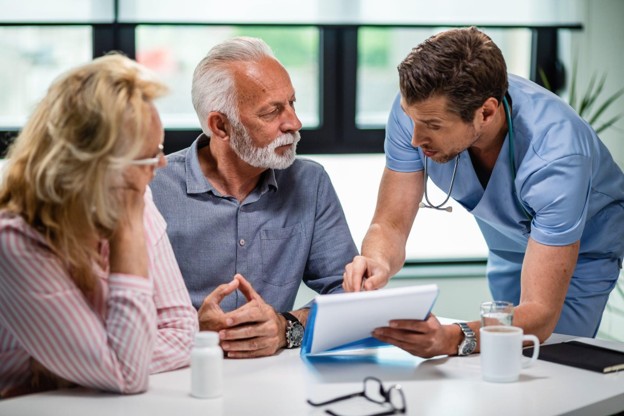 An adult patient discussing a personalized treatment plan with a physician during a surgical evaluation