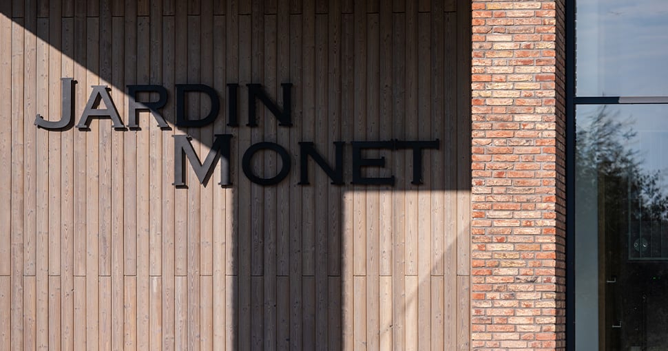 Detail foto van letters Jardin Monet op gevel de Scheg Wonen Limburg RO Groep