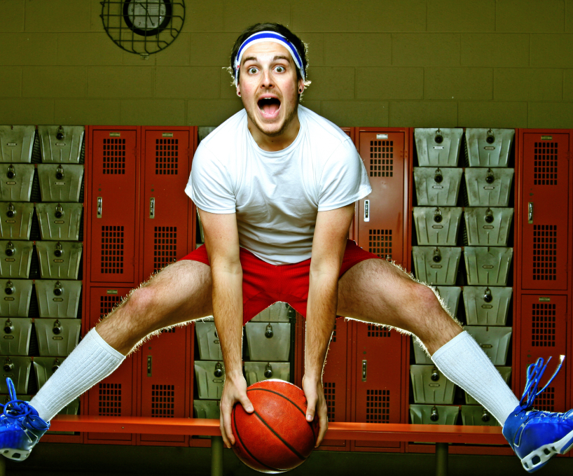 Man jumping holding basketball