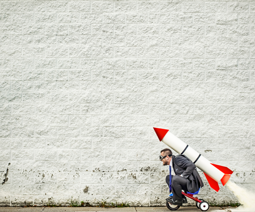 Man riding a bike with a rocket