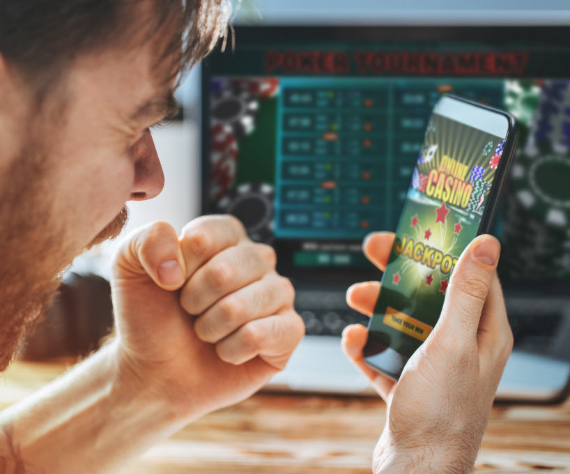 Man on phone playing an online casino and winning the jackpot 