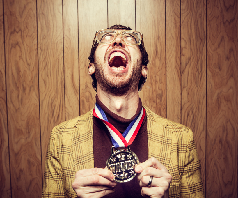 Man celebrating holding winner medal