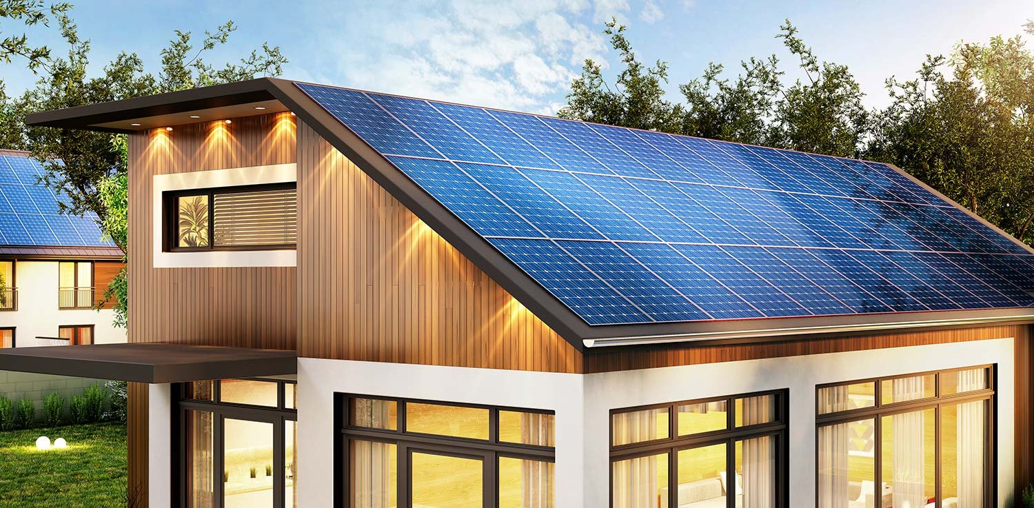 Modern house with solar panels on the roof being used as a sustainable energy source.