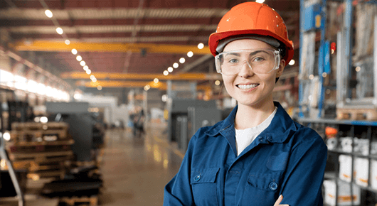 Woman wearing hardhat in factory 