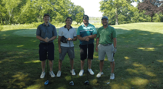 Energy Harbor representatives posing for photo on golf course during first charity golf classic