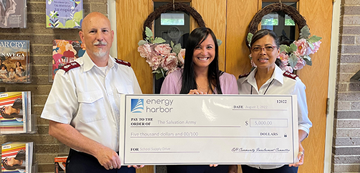 Energy Harbor and Salvation Army representatives posing with donation