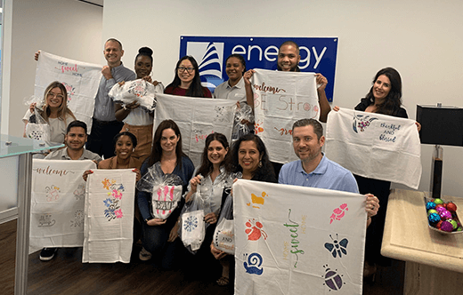 Energy Harbor employees holding blanket donations in group photo