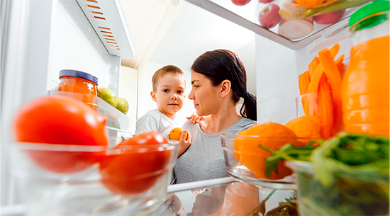 Image of woman and child looking in refrigerator