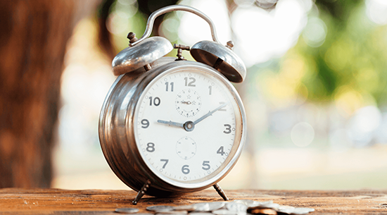 Old alarm clock with loose change