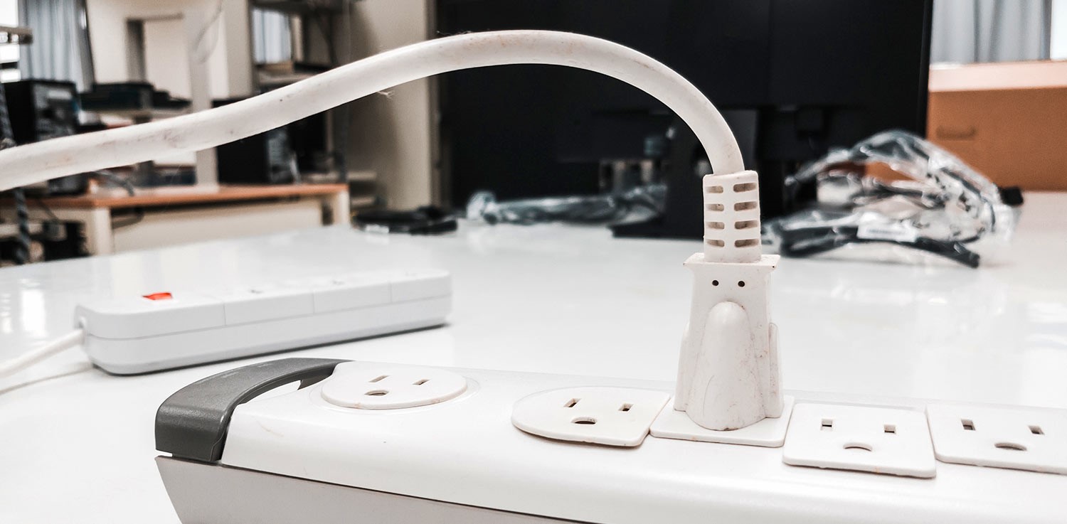 A power strip with one extension cord plugged in