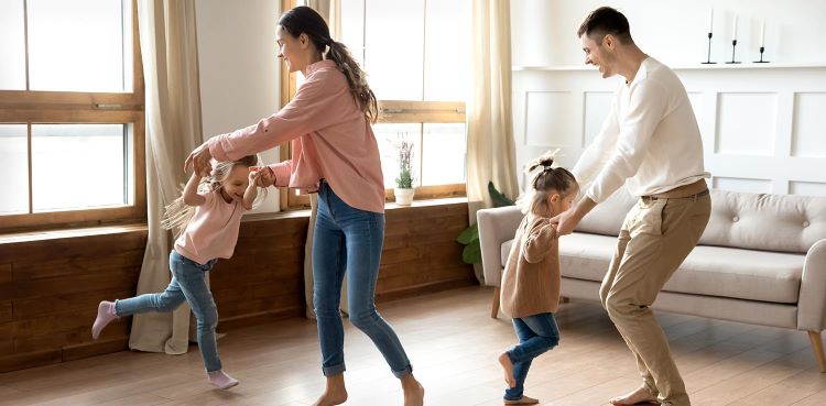 Family dancing together in home