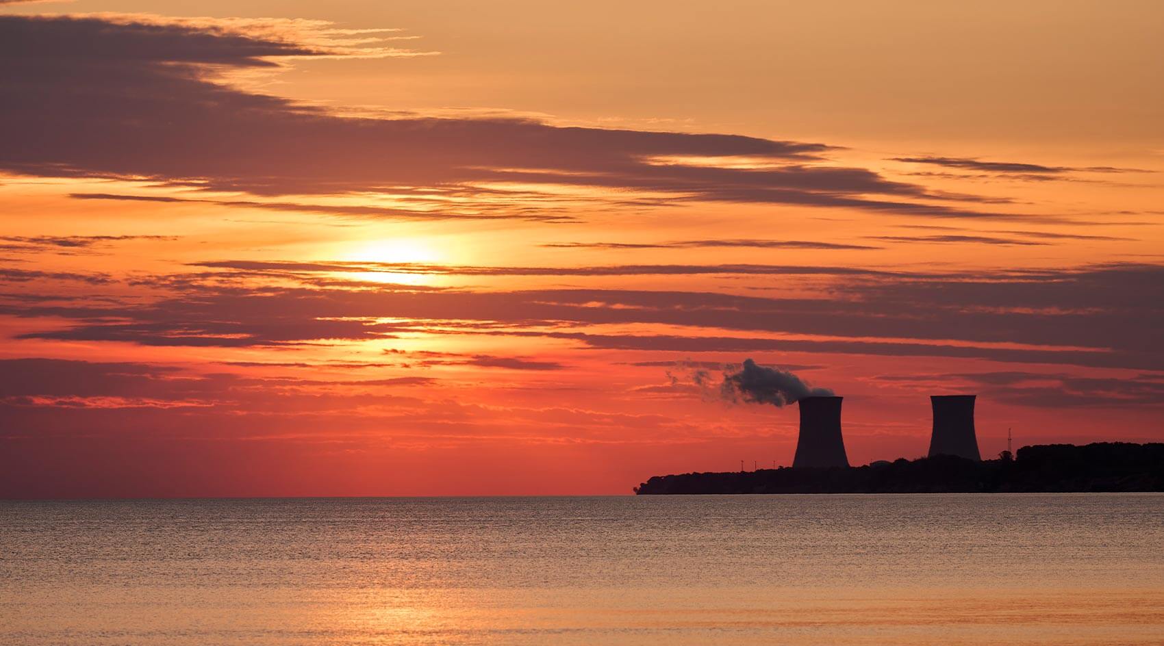 Cooling towers at sunset from across the lake