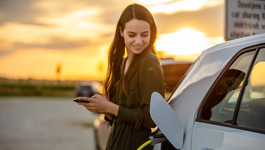 Woman smiling with car