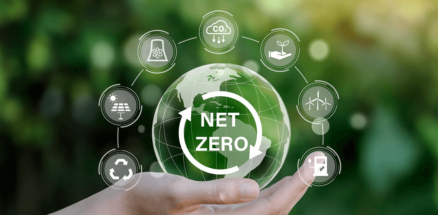 A hand holding a globe that reads Net Zero