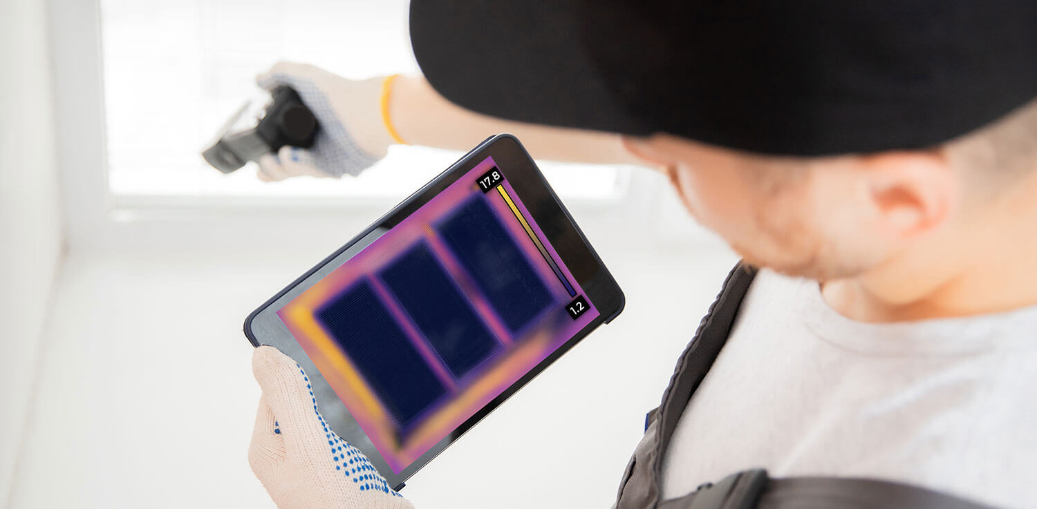 A professional uses thermographic scanning technology during an energy efficiency audit