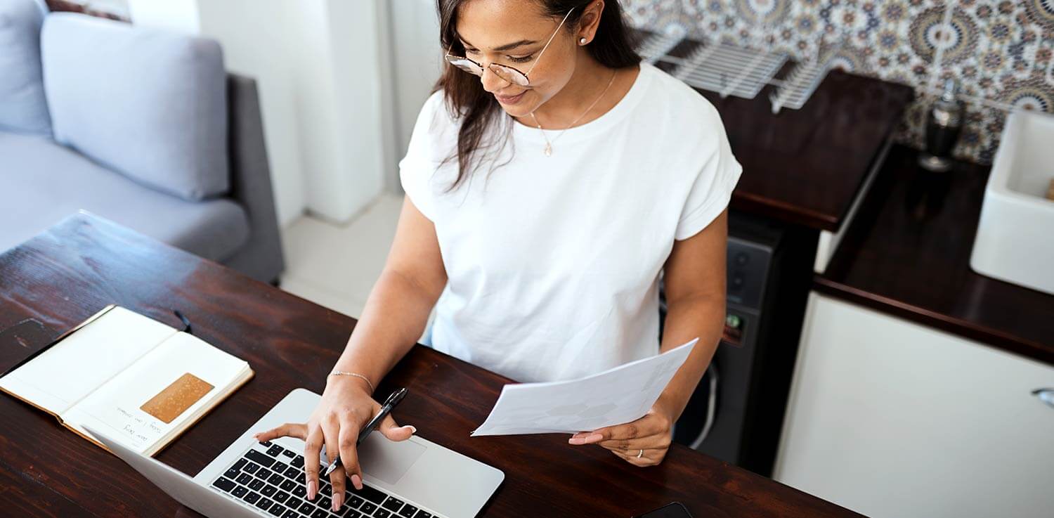 Woman checks her energy bill on a laptop.