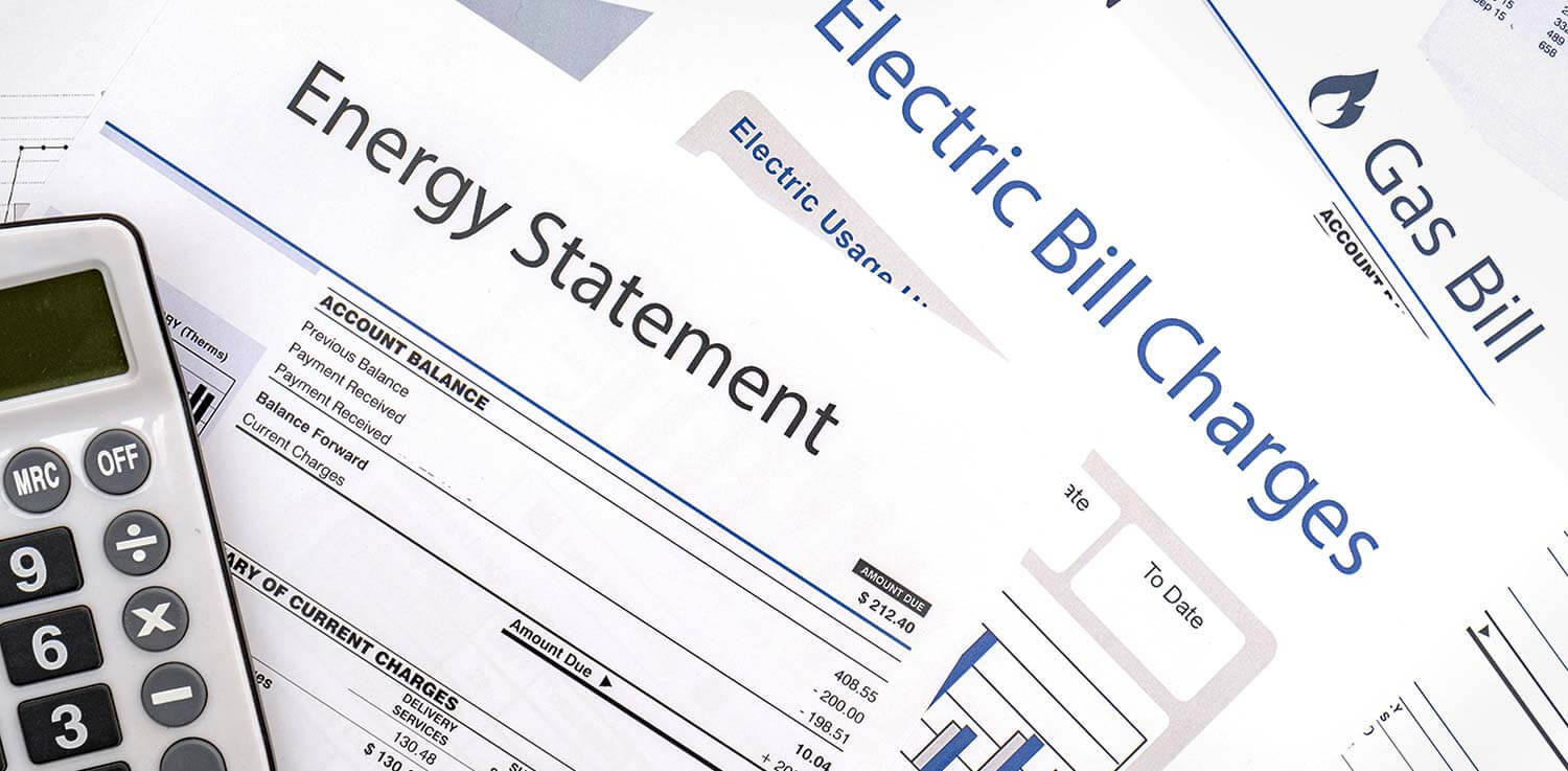 Utility bills and calculator spread on a table