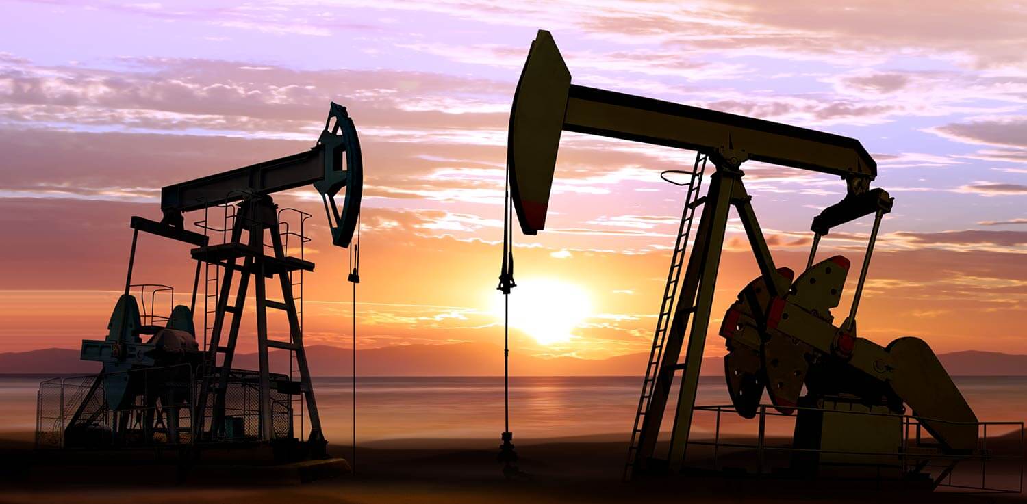Oil drilling machines at sunset.