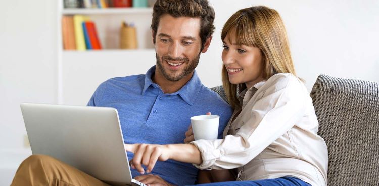 Couple looking at laptop comparing energy rates