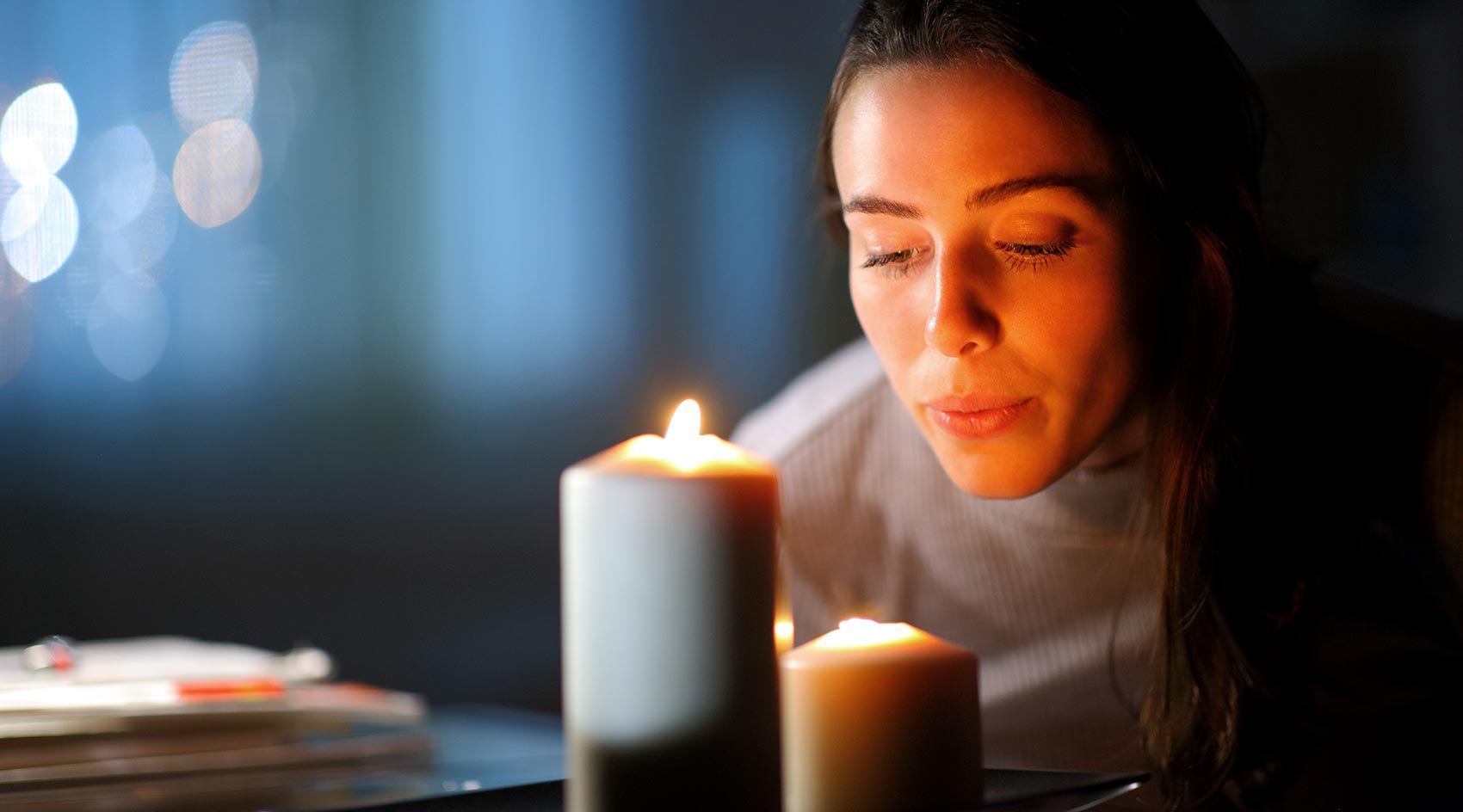 Woman lights candles during power outage