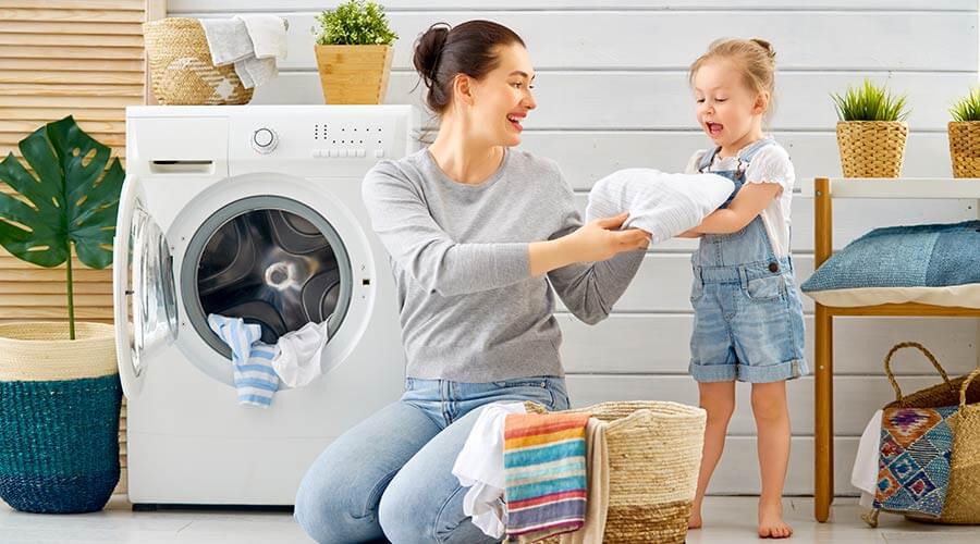 Mother and daughter folding laundry 