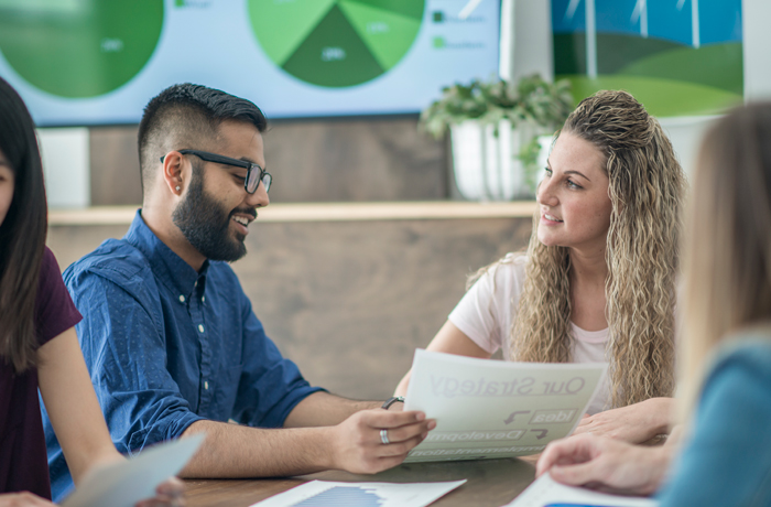 Business coworkers looking at report together